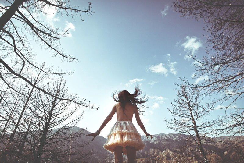 woman in skirt under blue sky