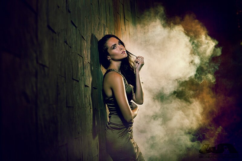 woman in smoke against wall