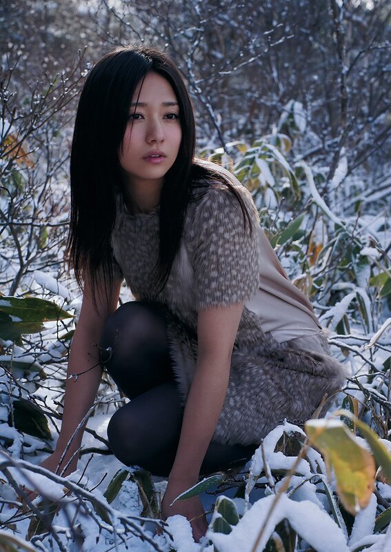 Woman in snow-covered forest