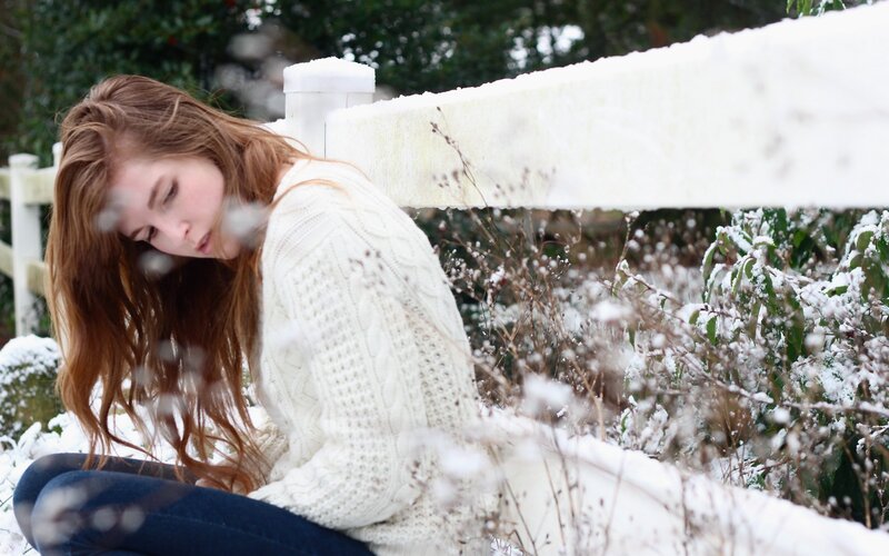 Woman in snow-covered garden