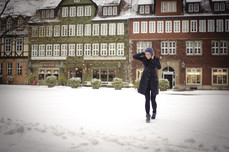 Woman in snow-covered town square