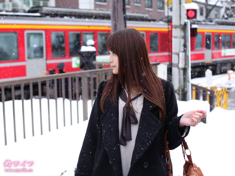 Woman in snow near train