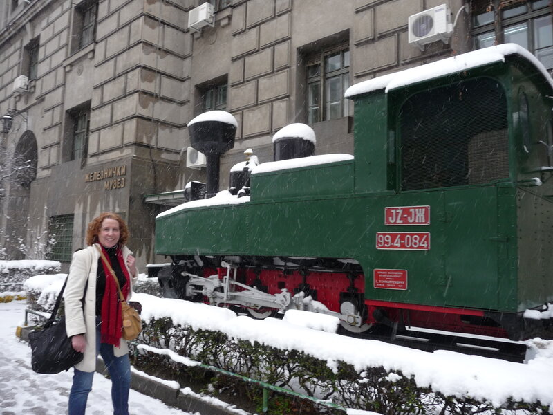 Woman in snow near train