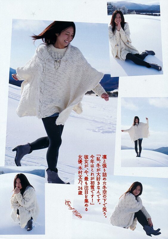 Woman in snow wearing white sweater