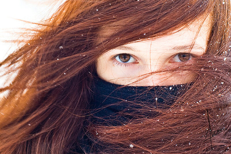 woman in snow with eyes visible