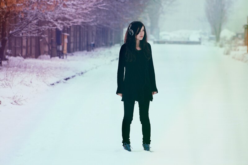 woman in snow with headphones