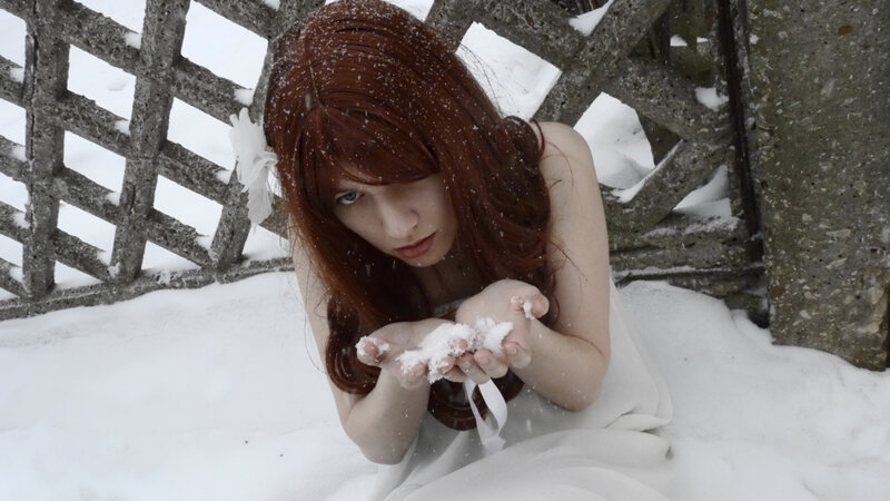 Woman in snow with red hair