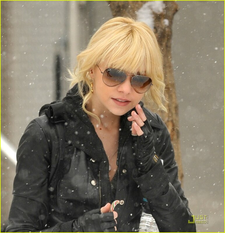 woman in snow with sunglasses
