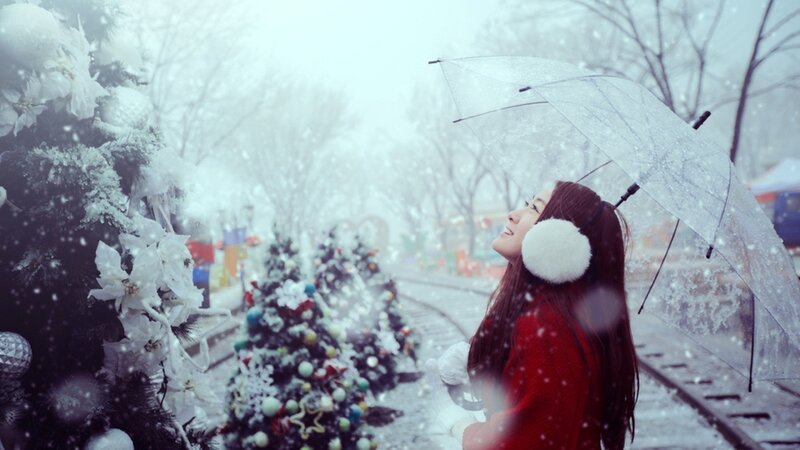 Woman in snow with umbrella