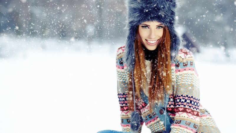 woman in snow with winter hat