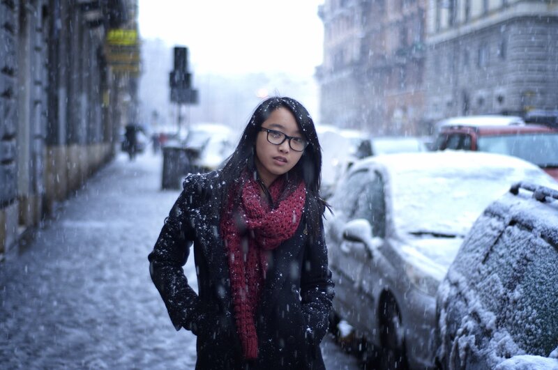 Woman in snowstorm on city street
