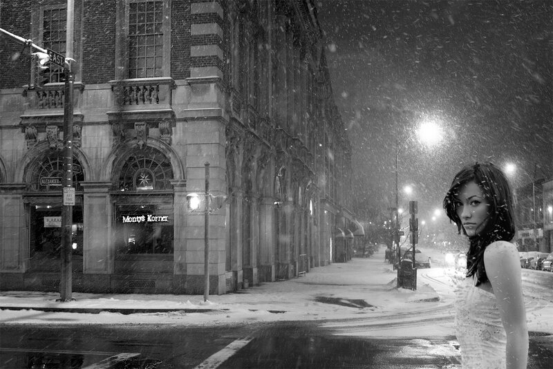 Woman in snowstorm on city street