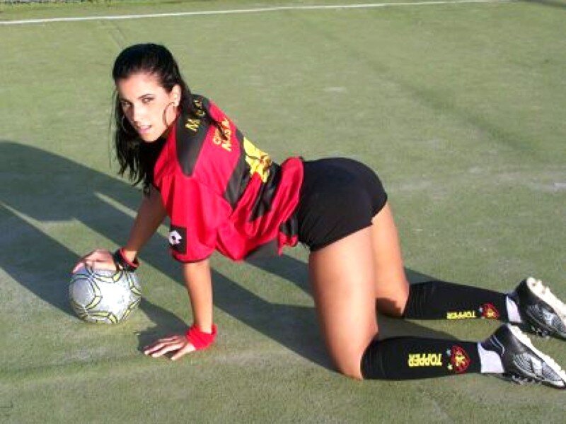woman in soccer uniform on field