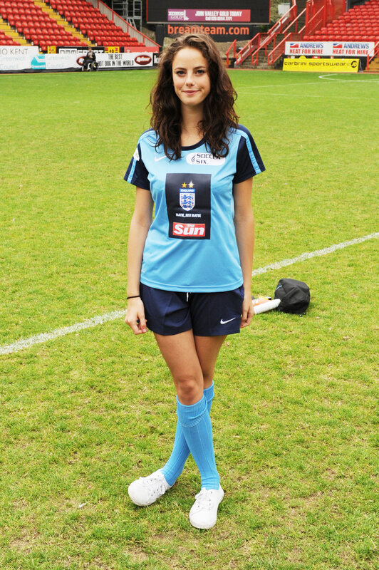 woman in soccer uniform on field