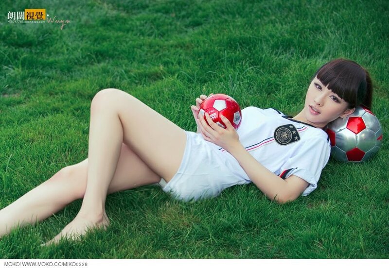 Woman in soccer uniform on grass