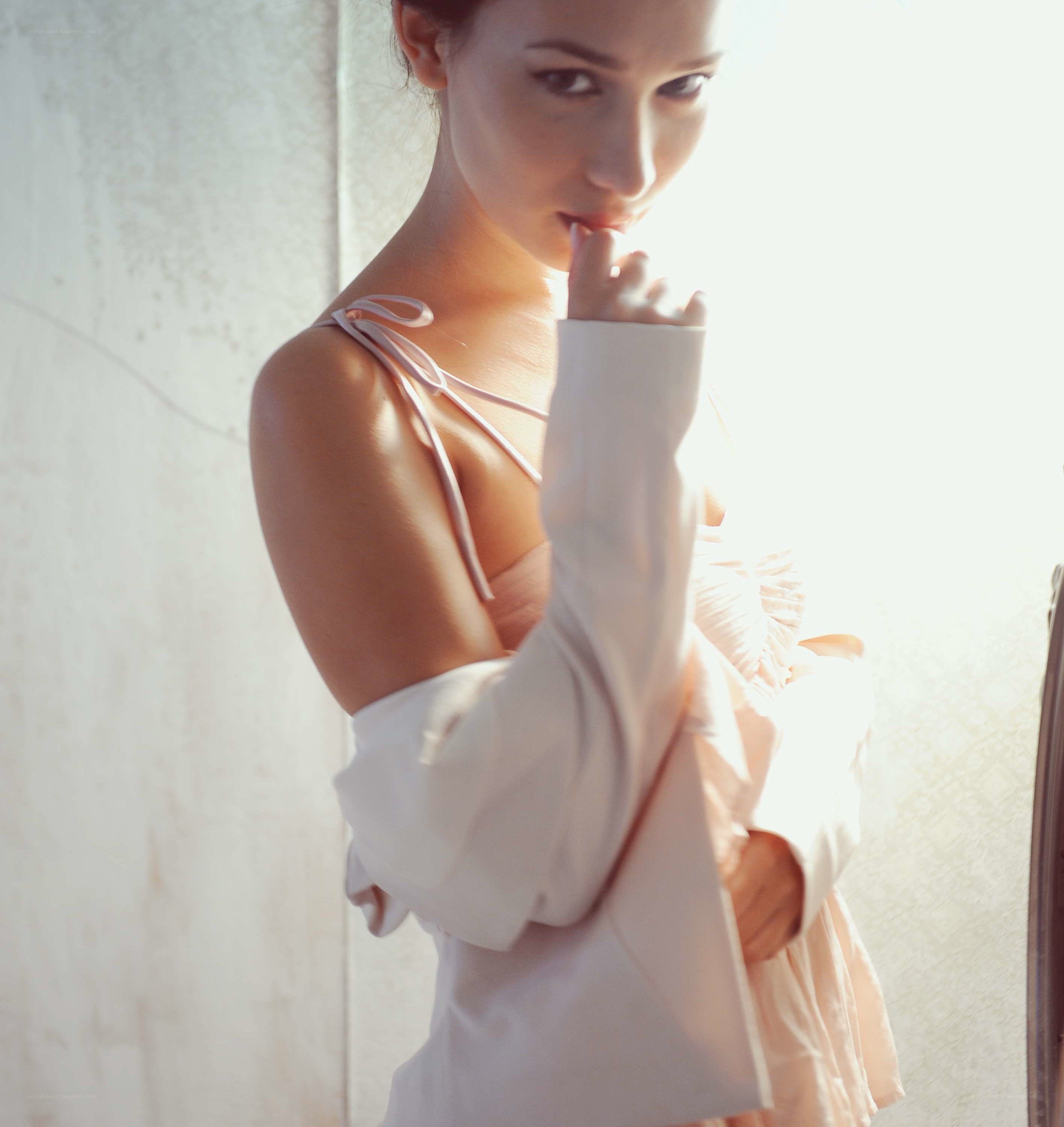 woman in soft light by window