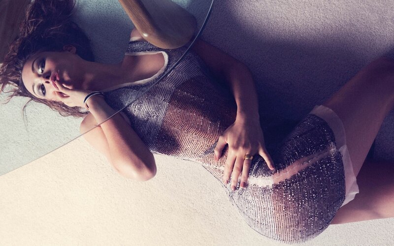 woman in sparkly dress lying down