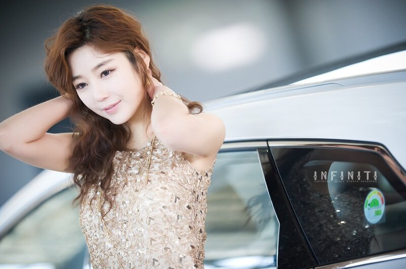 woman in sparkly dress near car