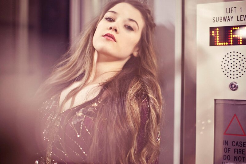 woman in sparkly dress near elevator