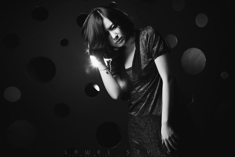 woman in sparkly dress with light