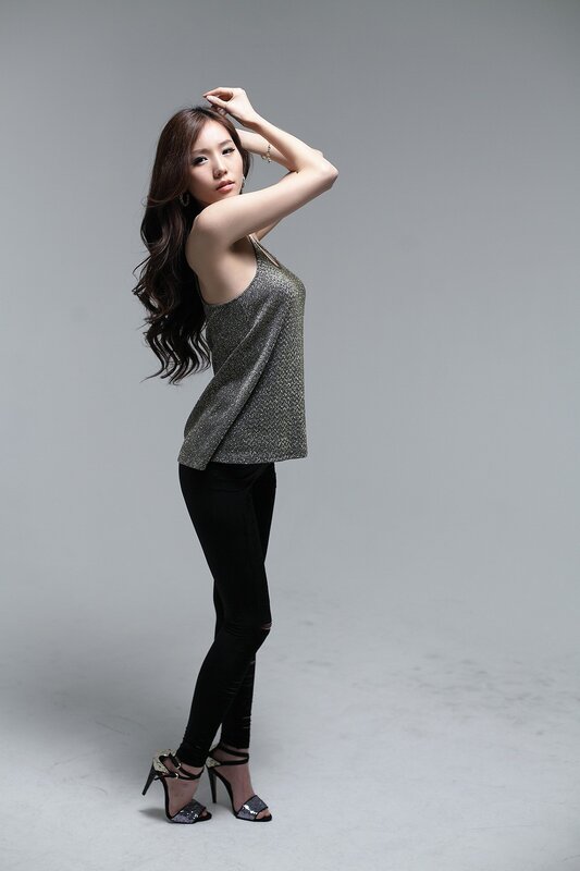 woman in sparkly top and black pants