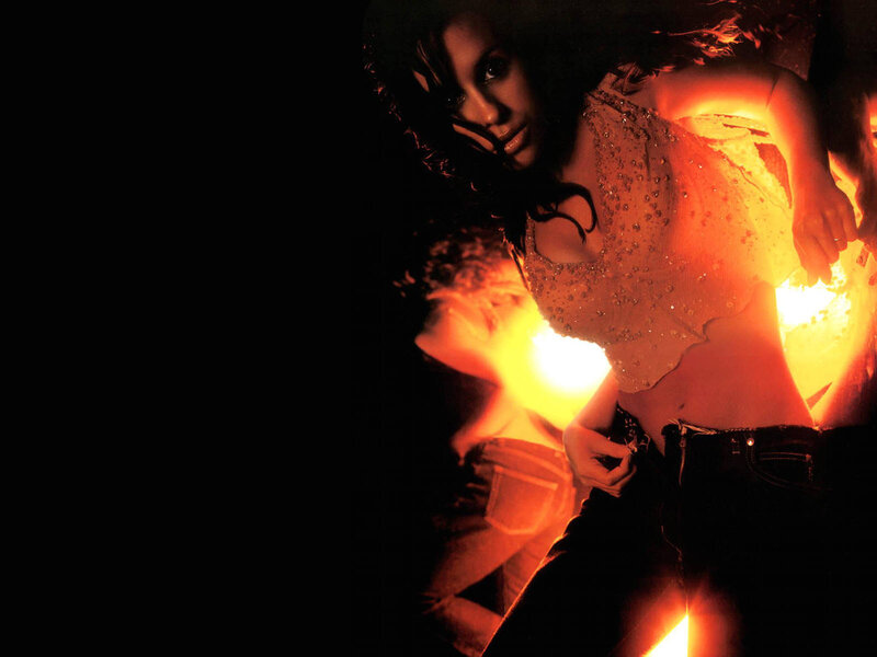 woman in sparkly top near fire