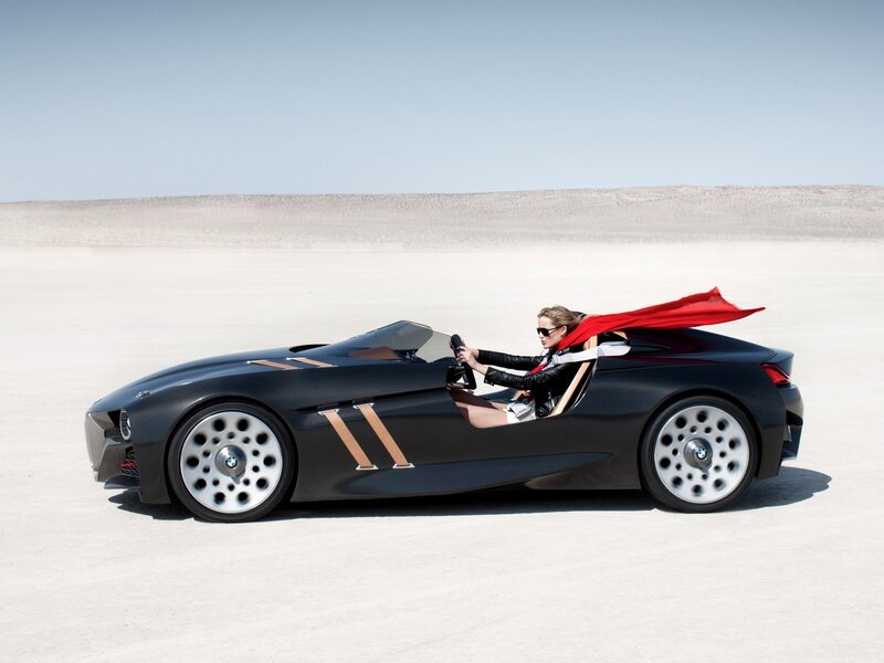 Woman in sports car on desert