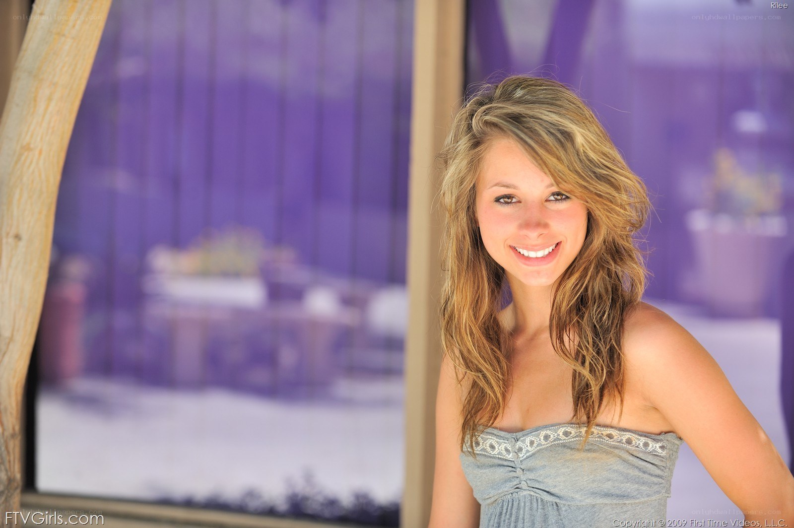 woman in strapless top smiling