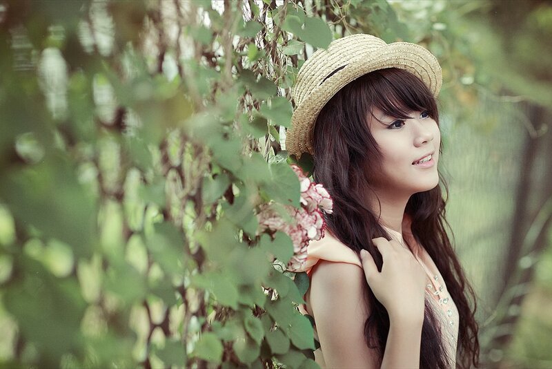 woman in straw hat among greenery
