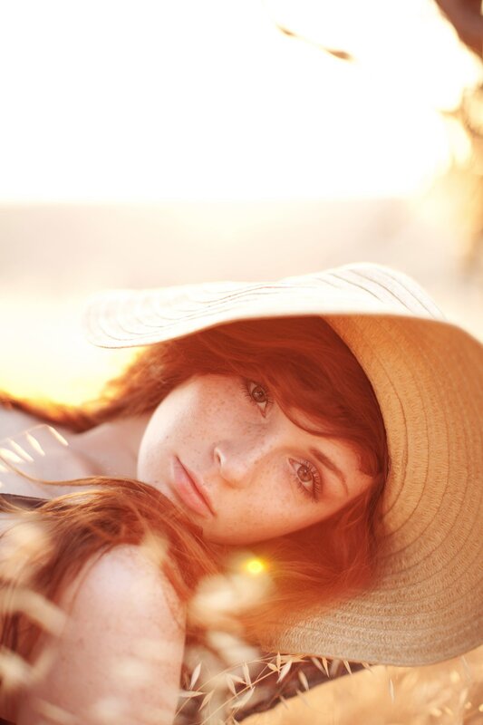 woman in straw hat at sunset
