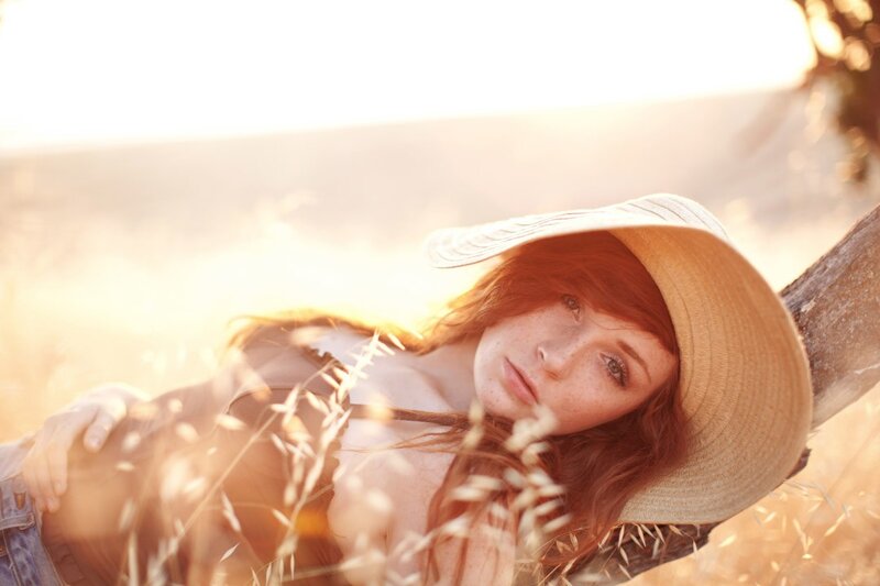 woman in straw hat at sunset