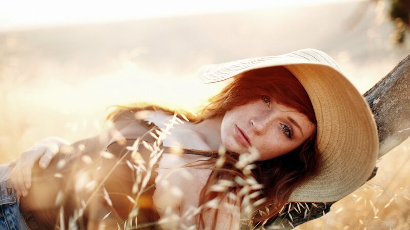 woman in straw hat at sunset