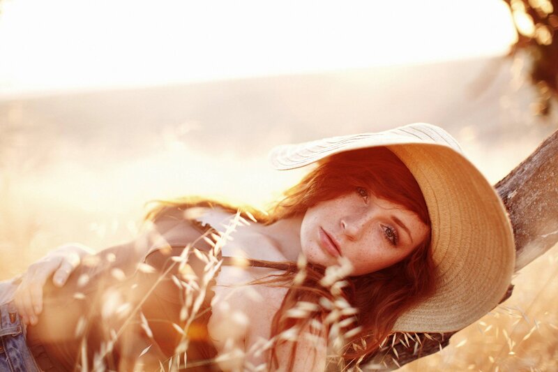 woman in straw hat at sunset