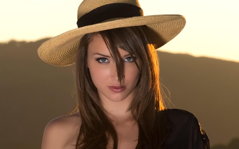 woman in straw hat at sunset