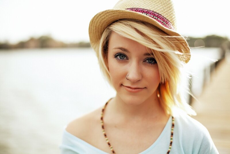 woman in straw hat by water