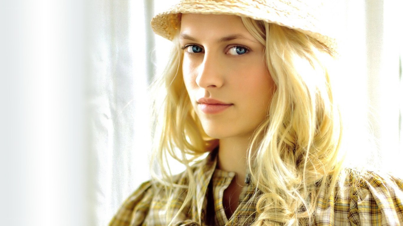 woman in straw hat by window