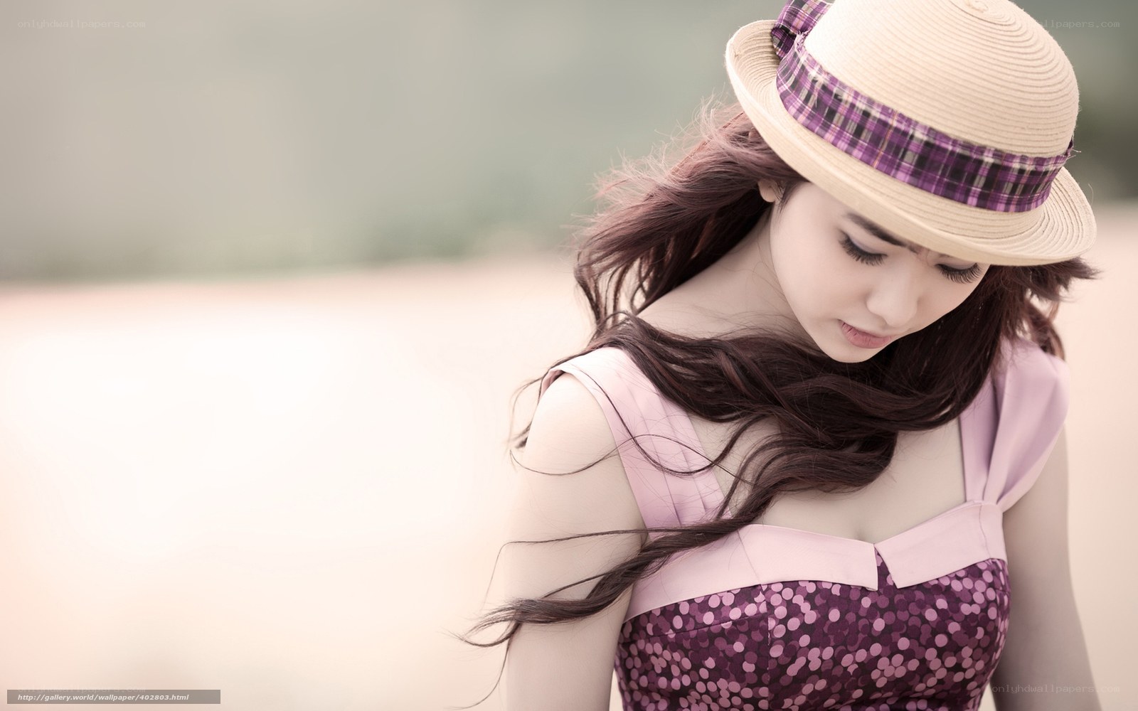 woman in straw hat looking down