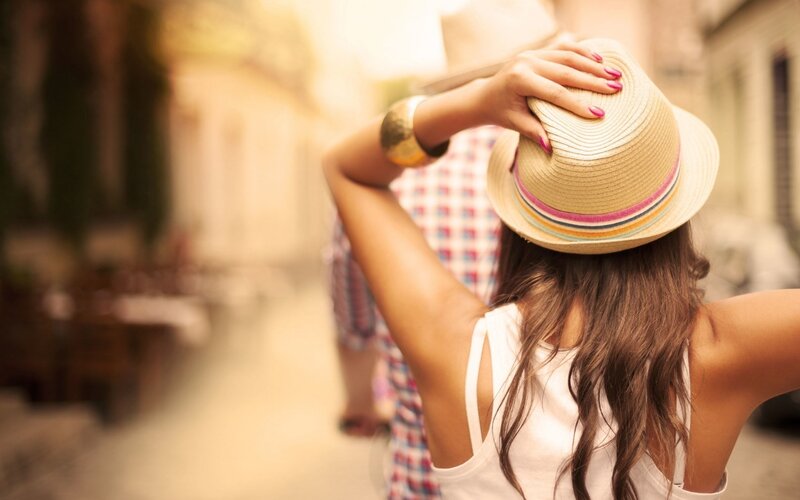woman in straw hat on street