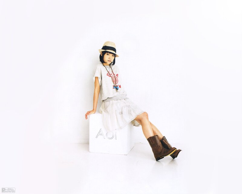 Woman in straw hat sitting on box