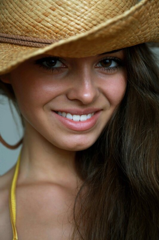 woman in straw hat smiling