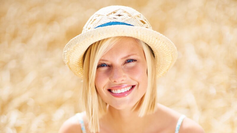 woman in straw hat smiling
