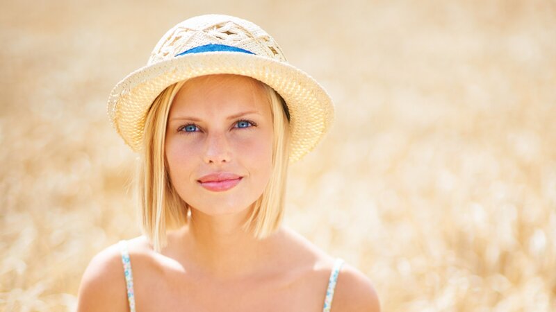woman in straw hat smiling