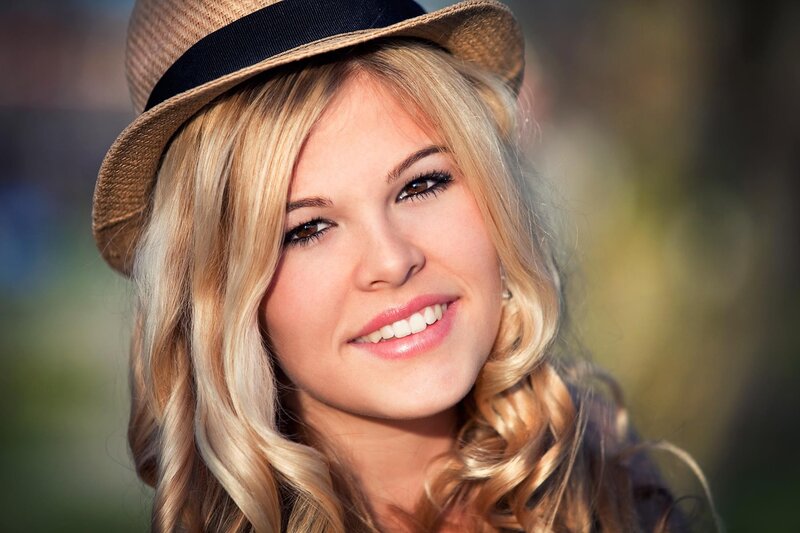 woman in straw hat smiling