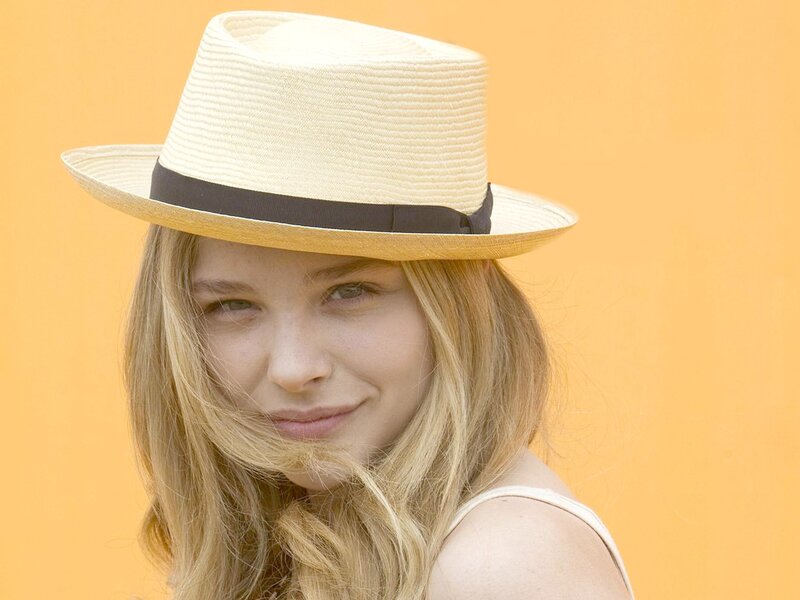 woman in straw hat smiling