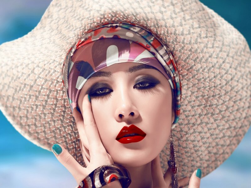 woman in straw hat with bold makeup