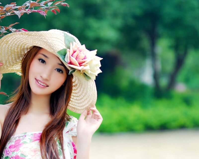 woman in straw hat with flower