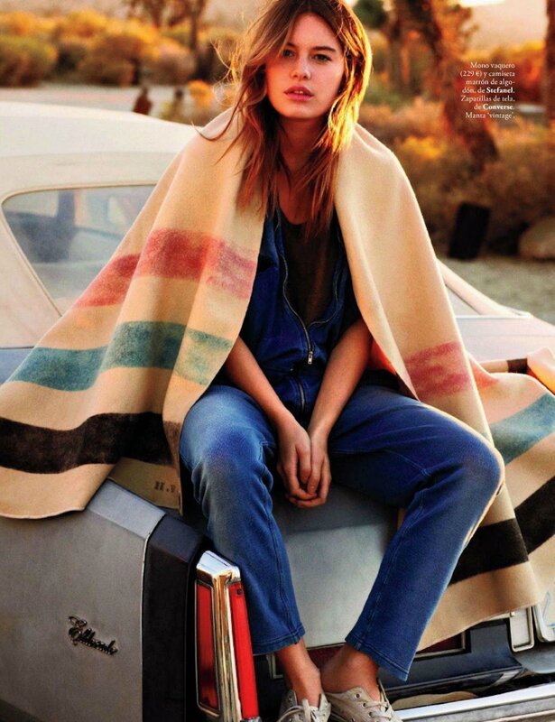 woman in striped blanket on car