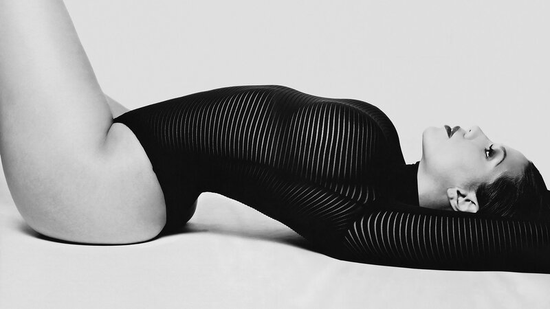 woman in striped bodysuit lying down