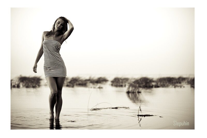 woman in striped dress at water's edge