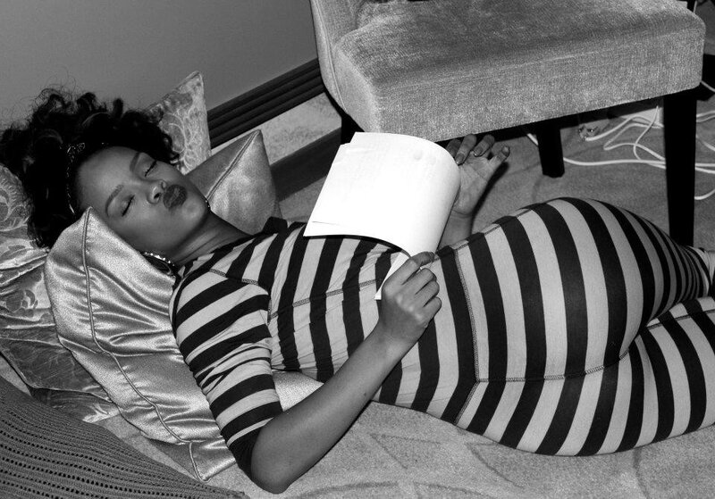 woman in striped dress reading